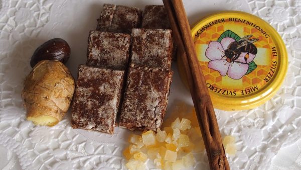 Close-up of my homemade Basler Läckerli (spiced gingerbreads) with ingredients