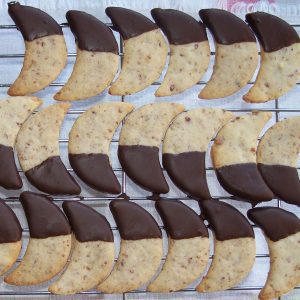 Homemade Mandelmöndli (chocolate-dipped almond crescents) on a cooling rack